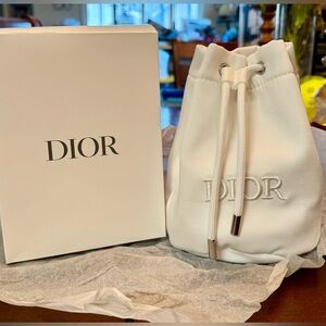 White Dior Bucket Bag pouch with silver accented pull string.